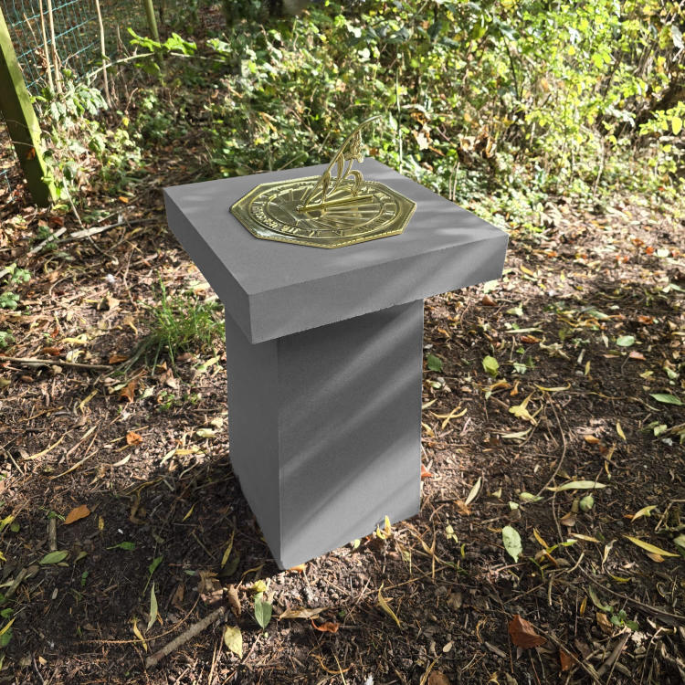 Contemporary Sundial in garden corner charcoal